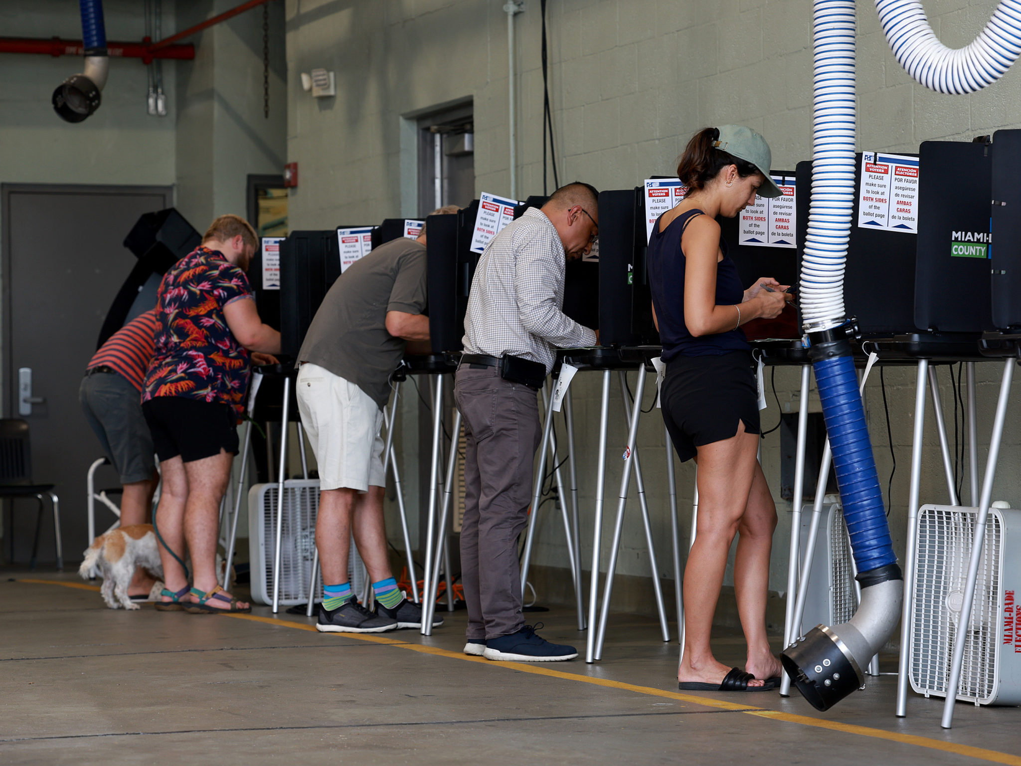 MIAMI BEACH, Florida - AUGUST 23: Voters cast their ballots at a polling station setup in a fire station on August 23, 2022 in Miami Beach, Florida. Voters across the state cast their ballots during the Florida Primary Elections. (Photo by Joe Raedle/Getty Images)